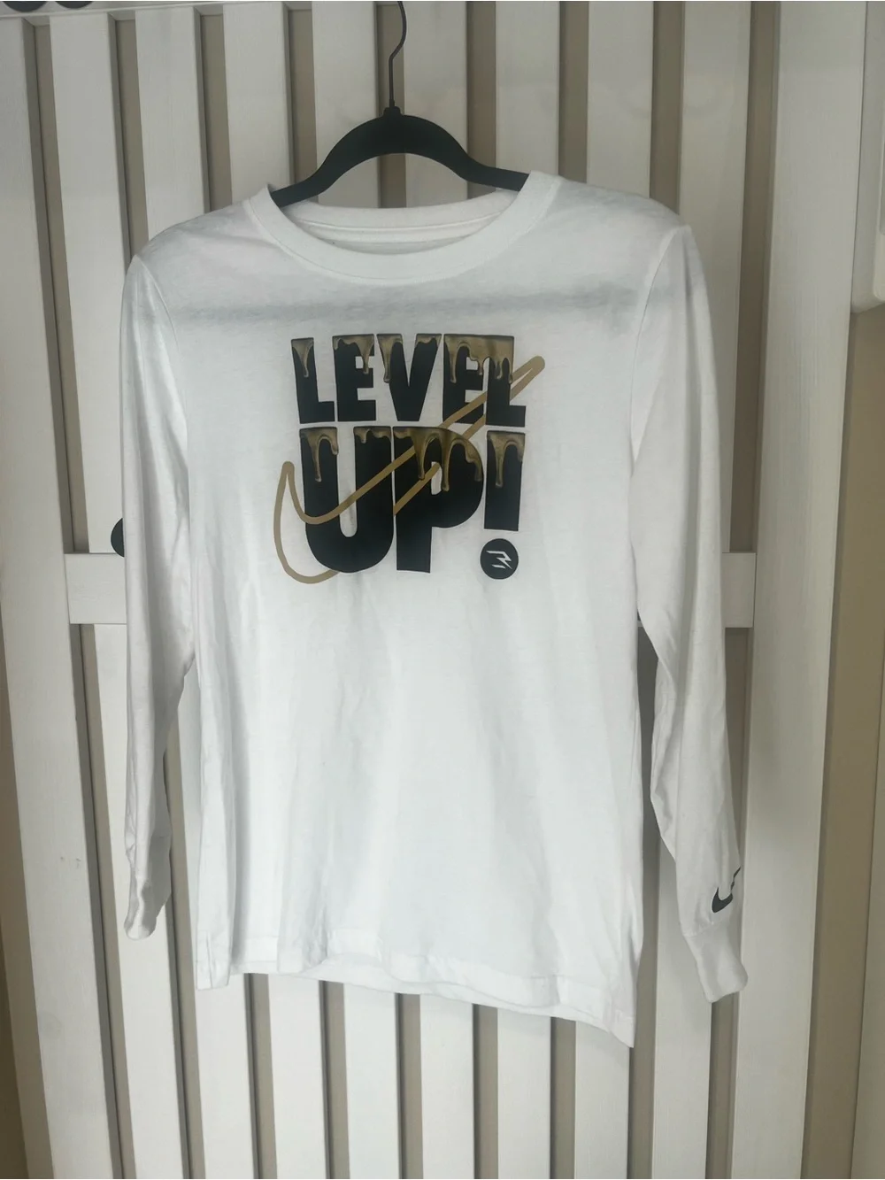 Nike Kids White Long Sleeve Tee with Black & Gold Drip Graphic